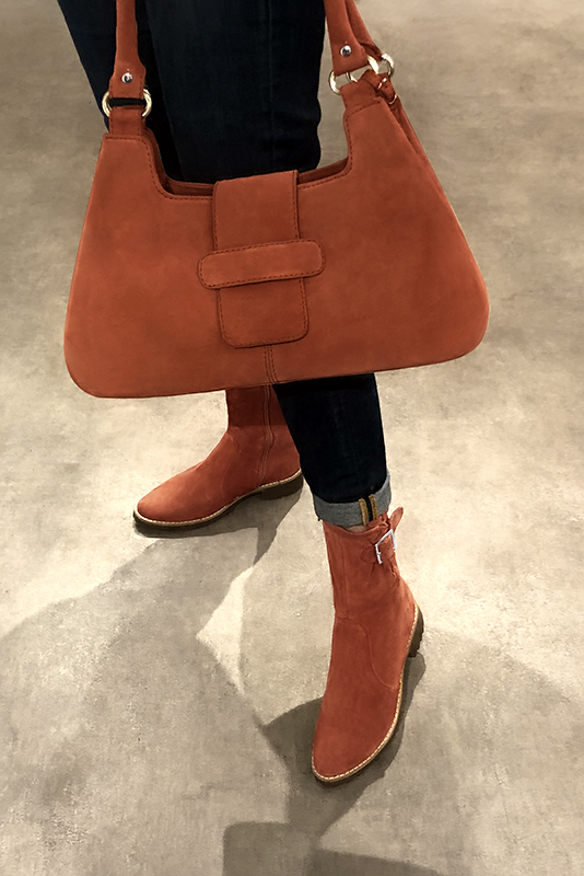 Terracotta orange women's ankle boots with buckles on the sides. Round toe. Flat rubber soles. Worn view - Florence KOOIJMAN
